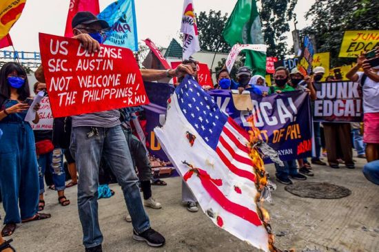 圖為新愛國聯盟成員昨日在計順市亞銀那洛軍營外焚燒美國國旗，抗議美國國防部長奧斯汀訪菲。